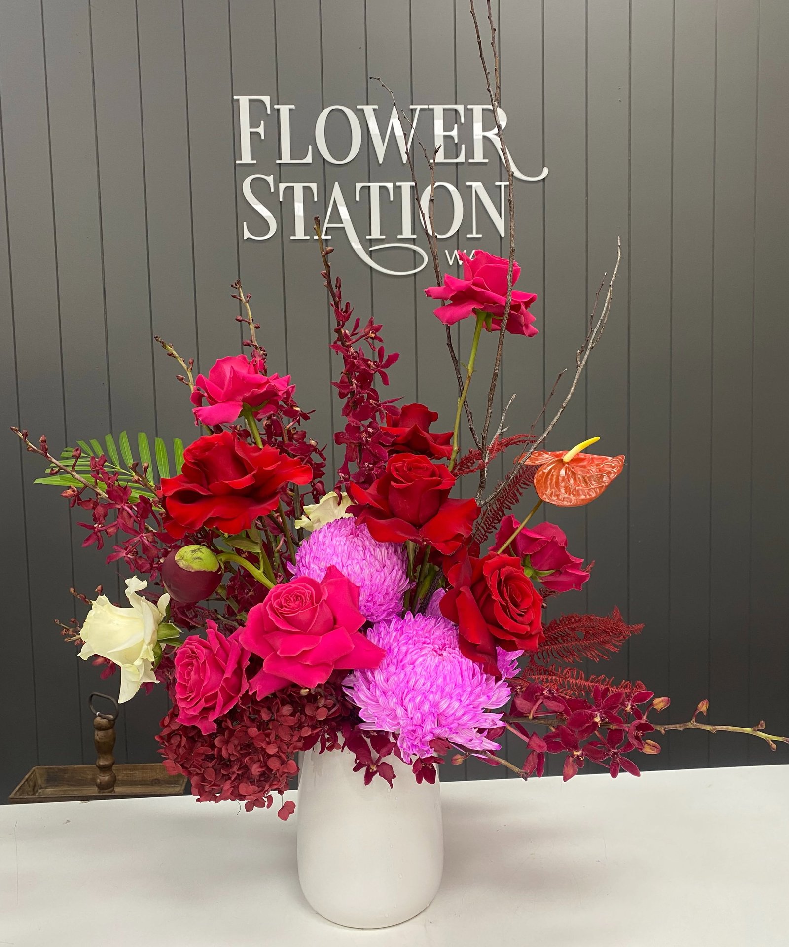 Pink and red floral arrangement in a white vase by Flower Station WA
