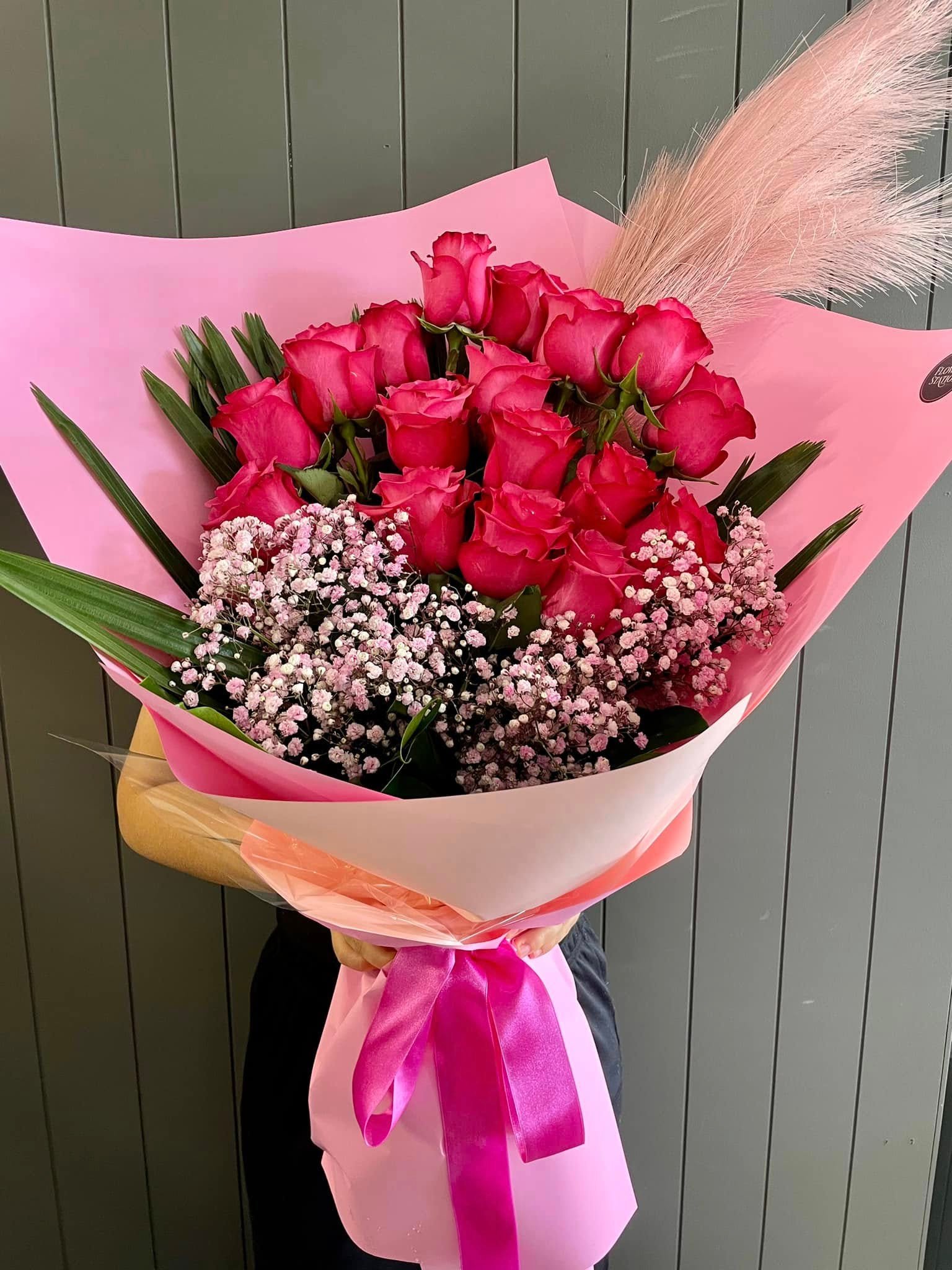Pink-wrapped rose bouquet by Flower Station WA